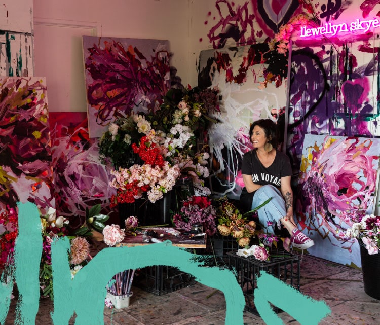 Artist Llewellyn Skye in studio surrounded by her muse, florals